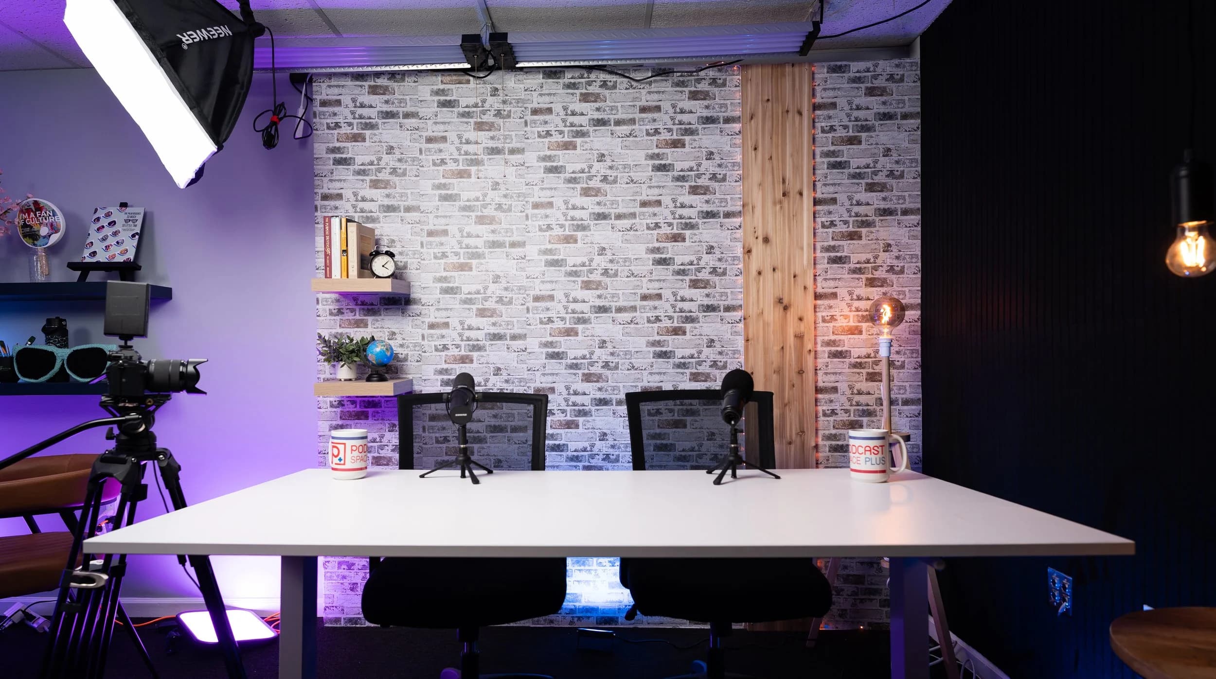 Podcast recording setup with microphones, camera, and professional studio lighting